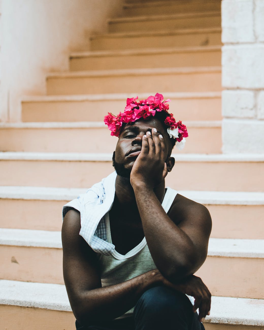 man wearing purple rose flower headband